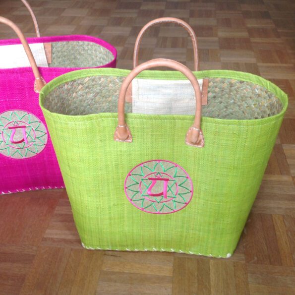 Colorful basket bag in apple green for the heart chakra with chakra symbol made of embroidery